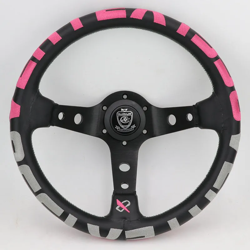 Black alloy racing steering wheel with deep concave rim and star embroidery pattern.