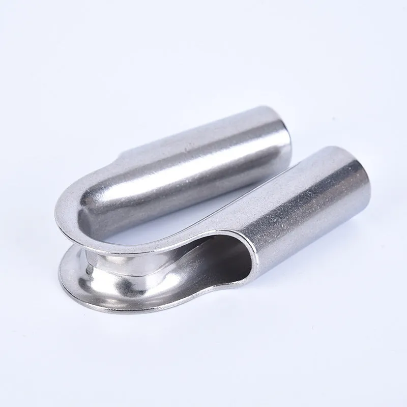 Set of stainless steel tubular chicken heart sleeve rings in various sizes on a workbench.