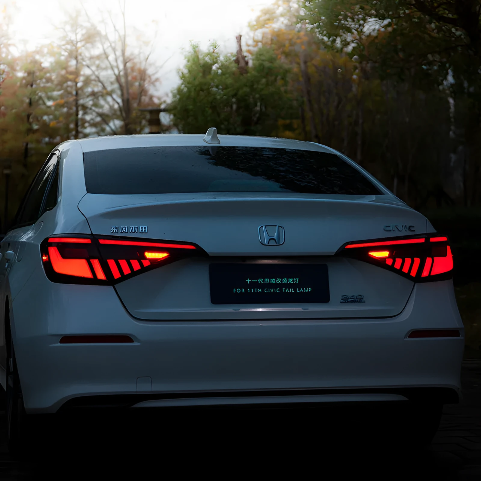 11th Generation Honda Civic modified LED taillight assembly with sequential streamer turn signals in black and red finish.