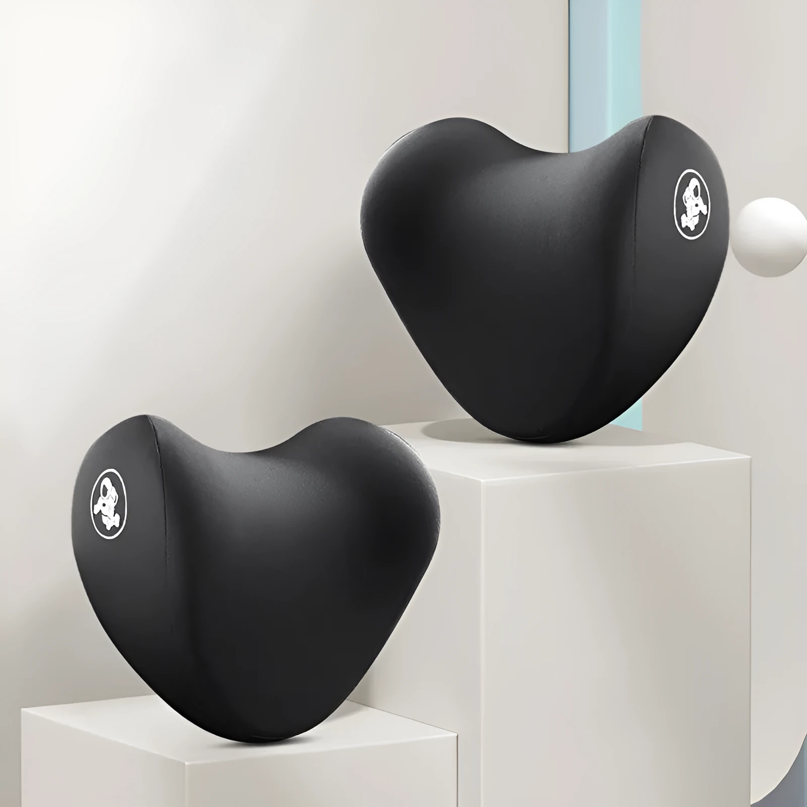 Heart-shaped car pillow in choice of colours, shown as headrest and lumbar support on a car seat.