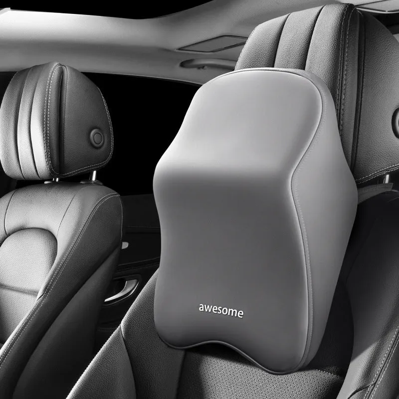 Black geometric pattern memory foam car lumbar pillow and matching headrest on a car seat.