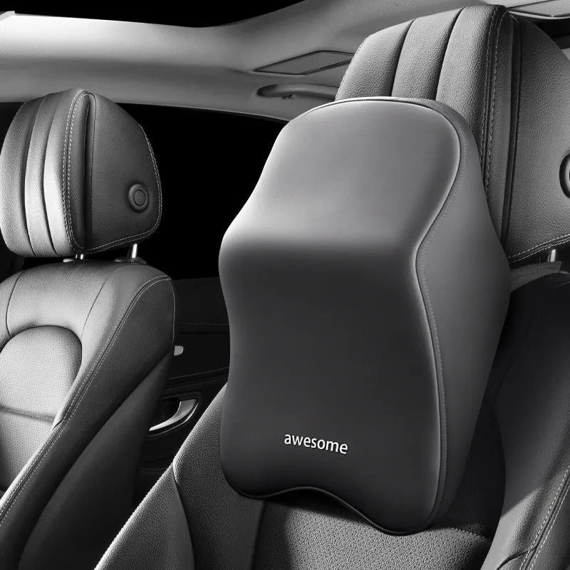 Black geometric pattern memory foam car lumbar pillow and matching headrest on a car seat.
