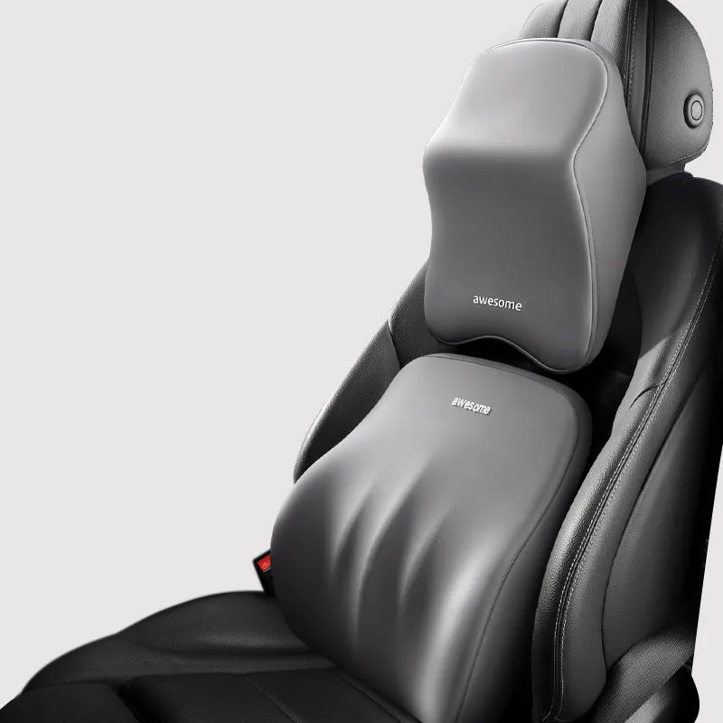 Black geometric pattern memory foam car lumbar pillow and matching headrest on a car seat.