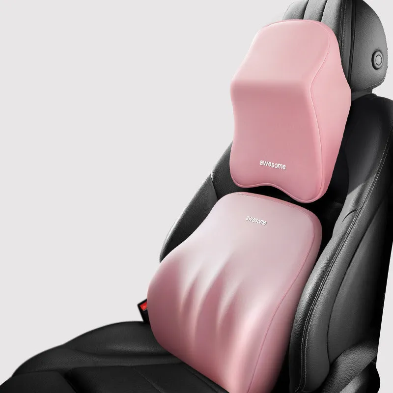 Black geometric pattern memory foam car lumbar pillow and matching headrest on a car seat.