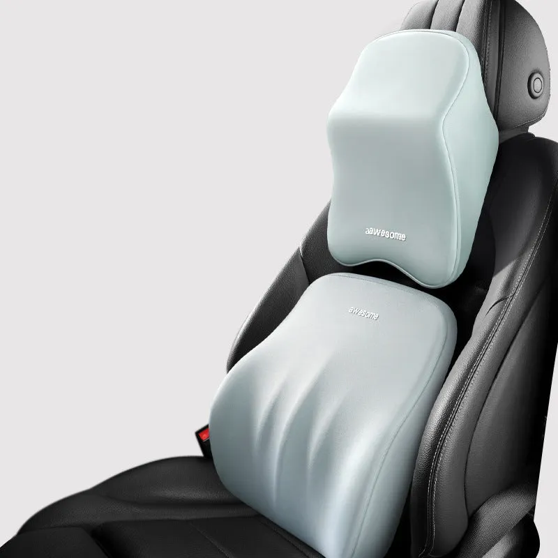 Black geometric pattern memory foam car lumbar pillow and matching headrest on a car seat.