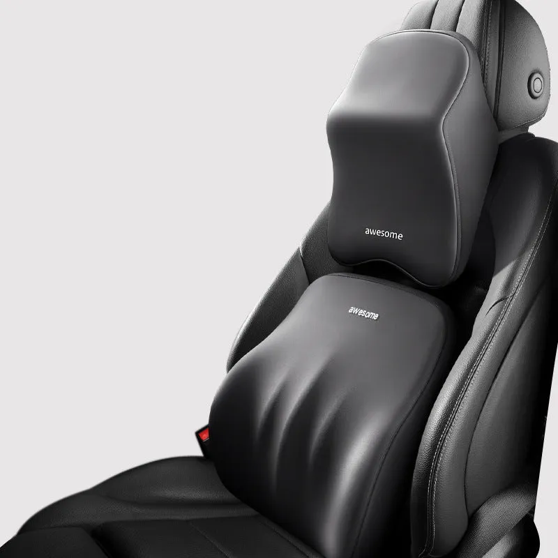 Black geometric pattern memory foam car lumbar pillow and matching headrest on a car seat.