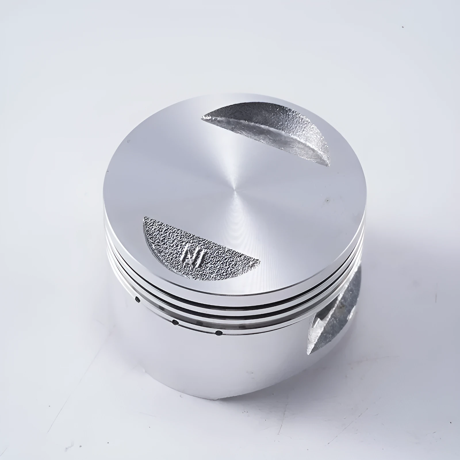 Motorcycle engine piston kit showing aluminium alloy construction with 57.4mm diameter measurement