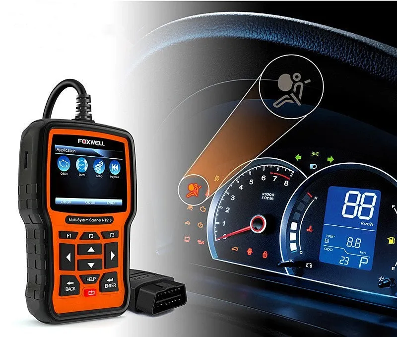 Foxwell NT510 orange and black automotive diagnostic scanner with data cable on a workshop bench.