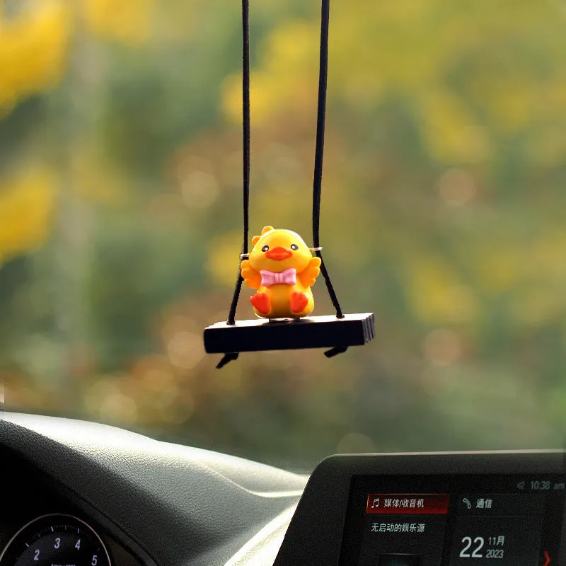 Cute little yellow plastic duck doll car hanging ornament in cartoon style.