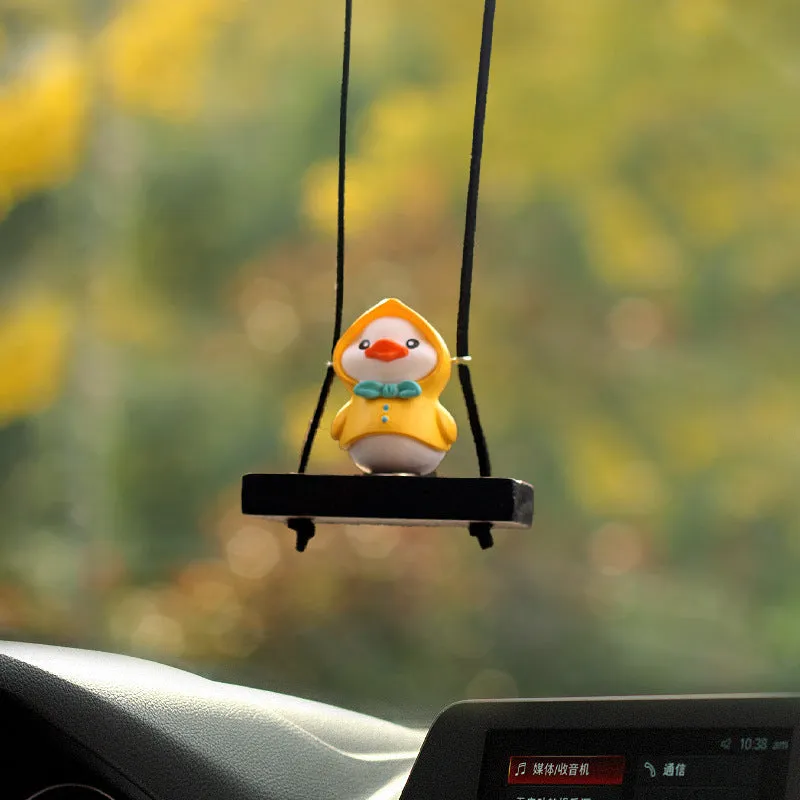 Cute little yellow plastic duck doll car hanging ornament in cartoon style.