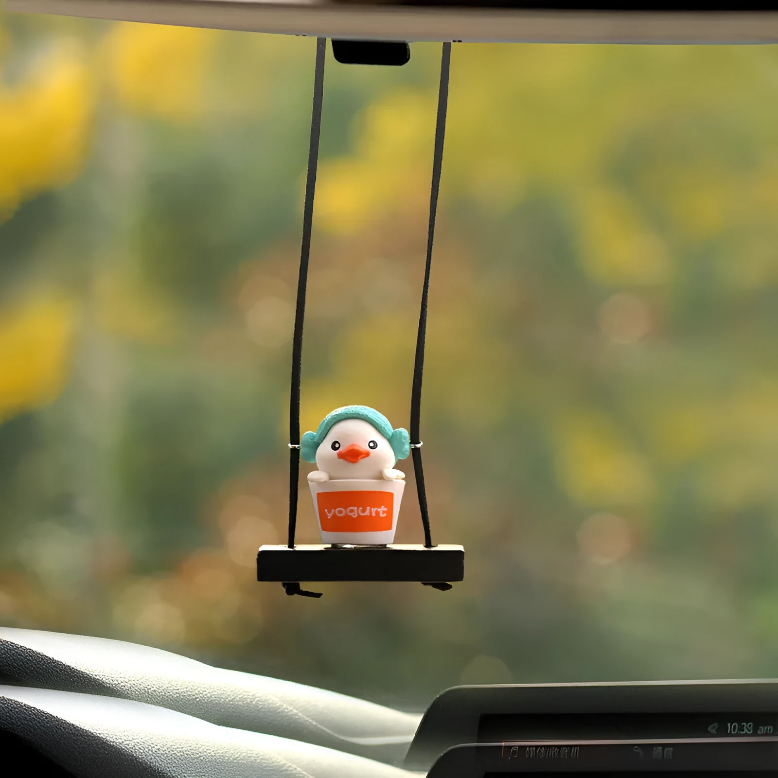 Cute little yellow plastic duck doll car hanging ornament in cartoon style.