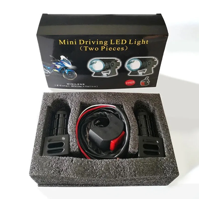 Motorcycle auxiliary spotlight with two-colour lens options, showing aluminium and polycarbonate housing.