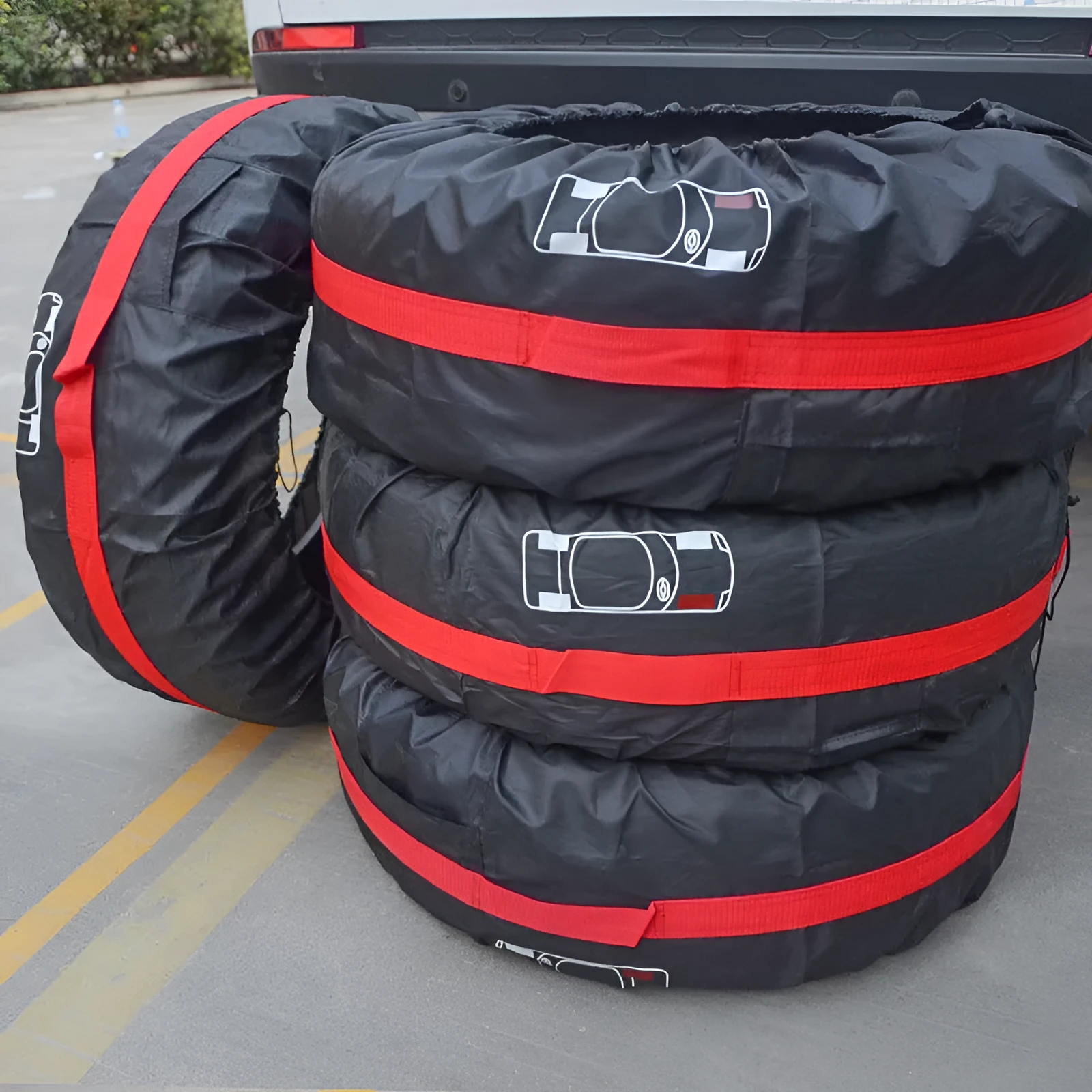 Black and red oxford cloth car tyre protective covers showing belt-style design with sizing labels