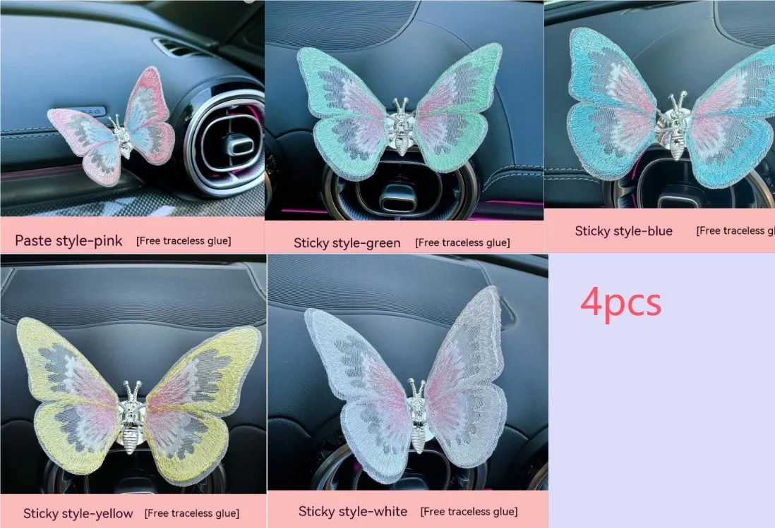Soft fabric embroidered butterfly car air vent decoration in multiple colour options on a centre console.