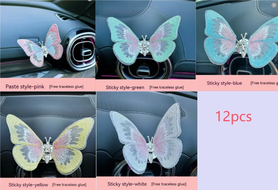 Soft fabric embroidered butterfly car air vent decoration in multiple colour options on a centre console.