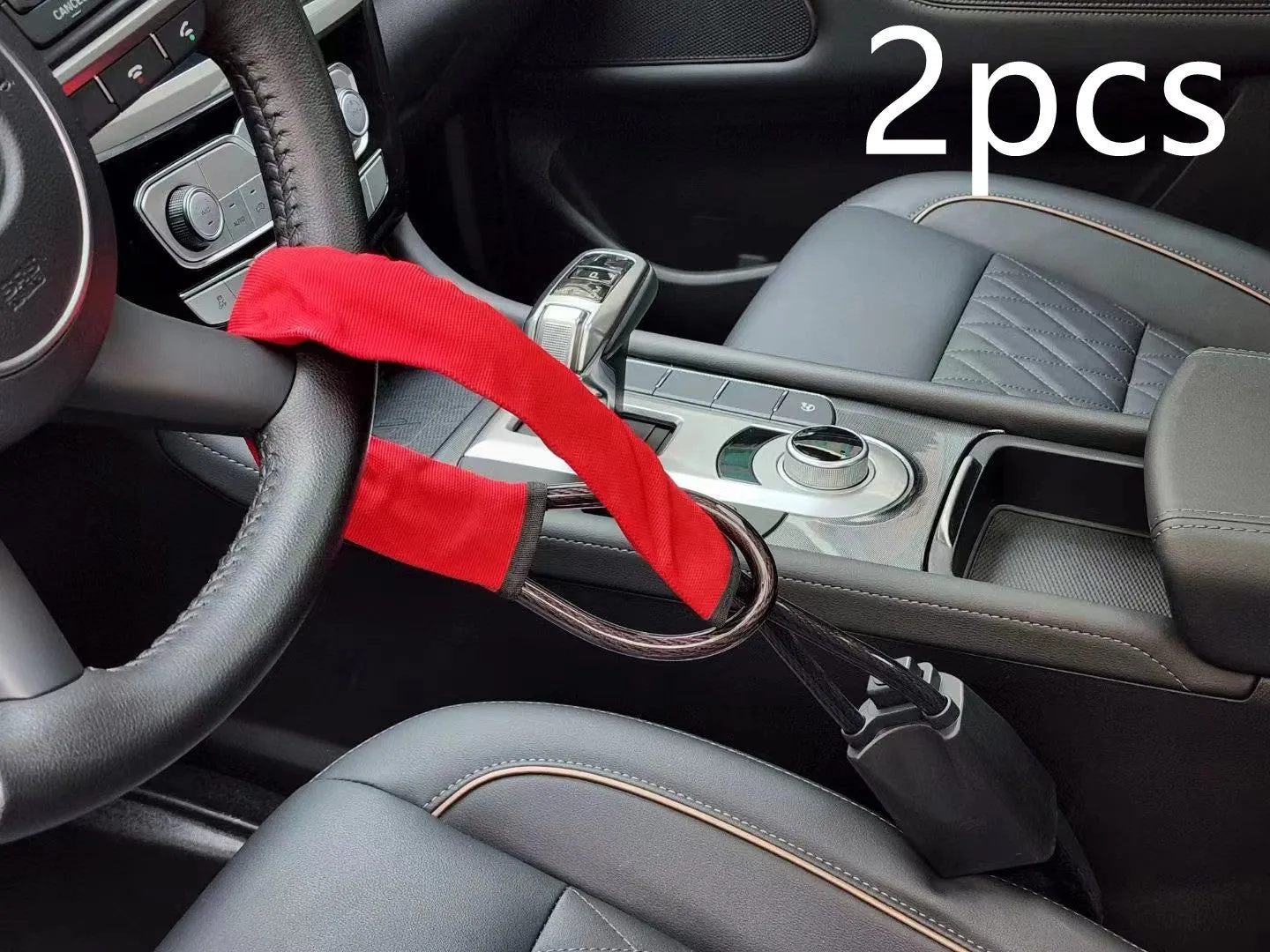 Red iron car steering wheel lock with copper core for General Motors vehicles on a steering wheel.