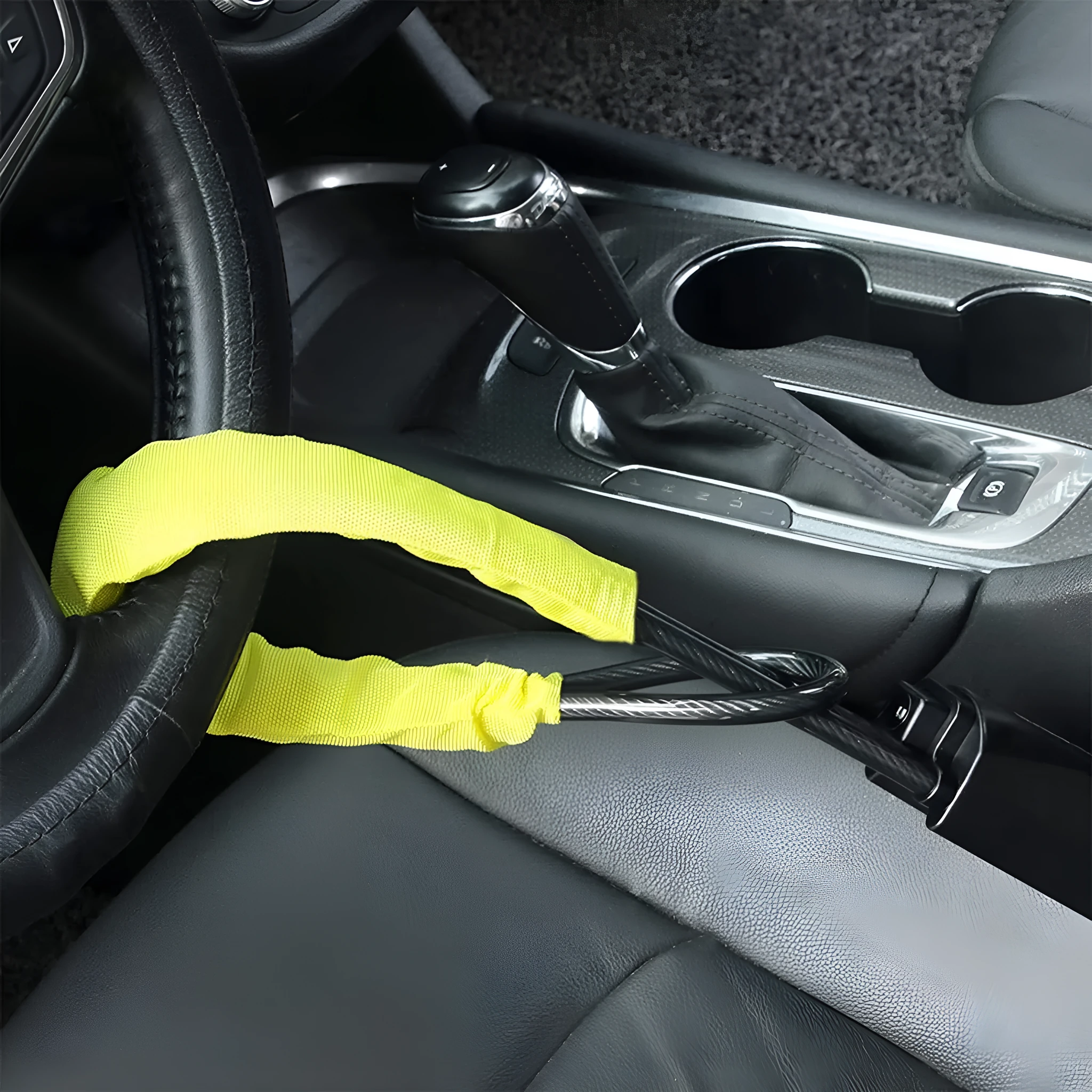 Red iron car steering wheel lock with copper core for General Motors vehicles on a steering wheel.