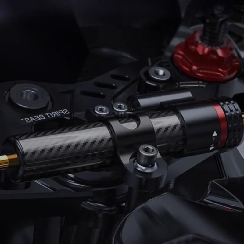 Titanium directional damper bracket with carbon fibre finish for CFMoto 450SR motorcycle.
