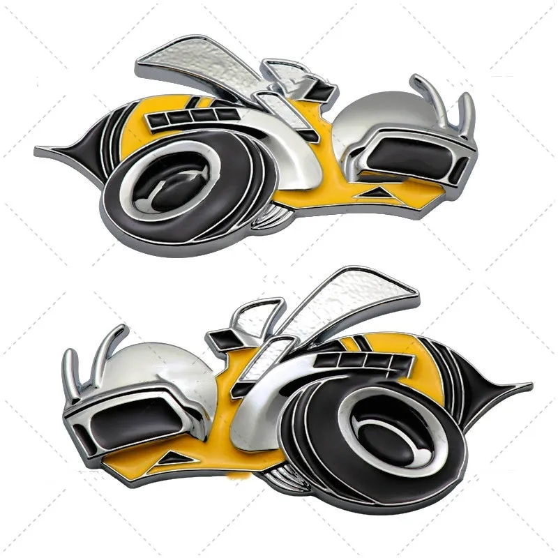 Pair of large yellow and silver Big Bee zinc alloy bumper stickers on a car bumper.