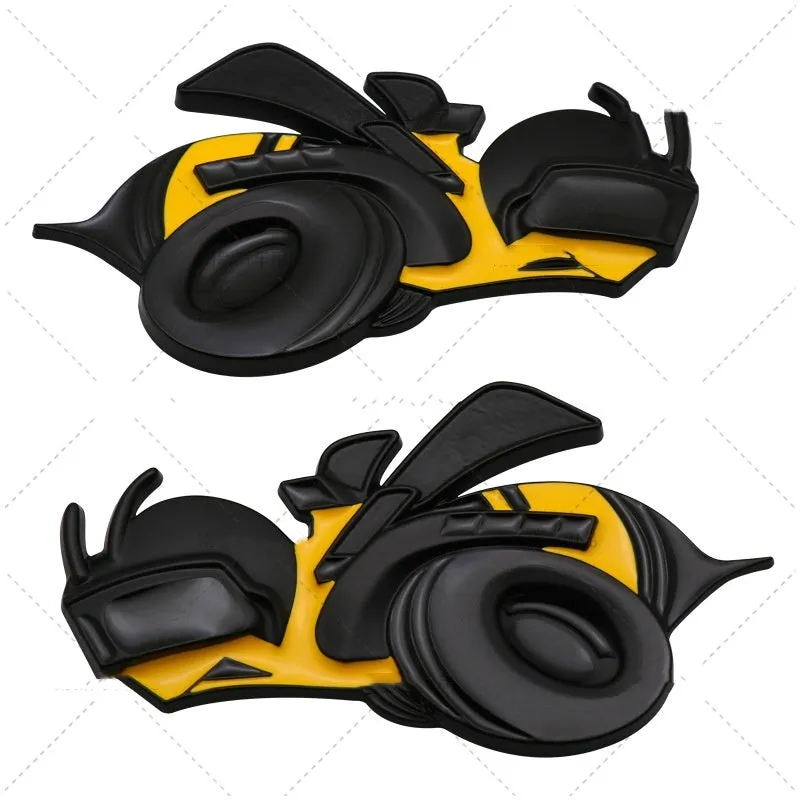 Pair of large yellow and silver Big Bee zinc alloy bumper stickers on a car bumper.
