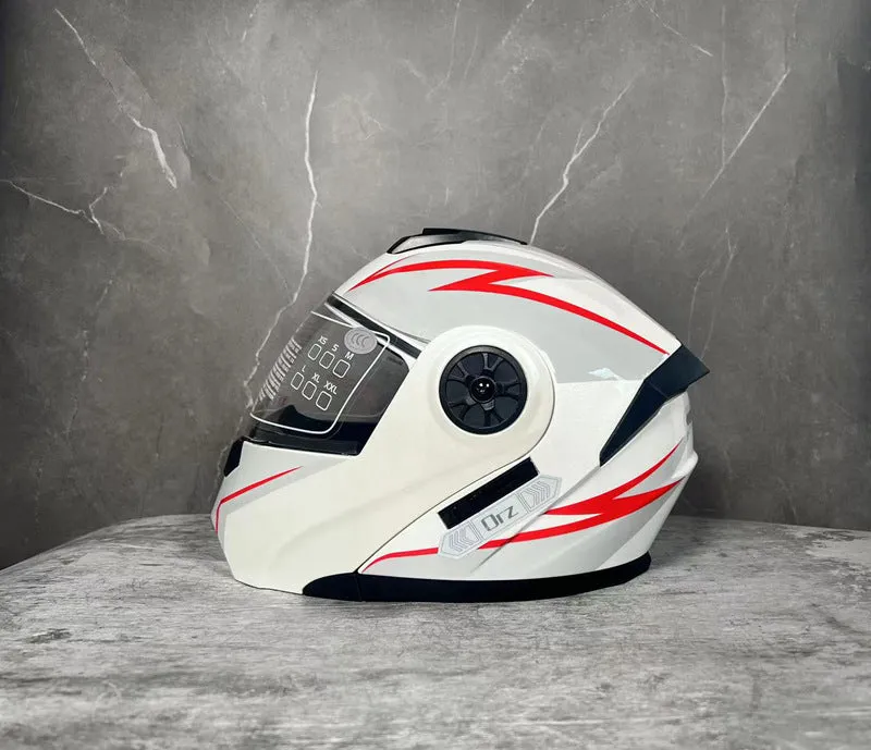 Matte black full face motorcycle helmet with integrated battery visor on a stand