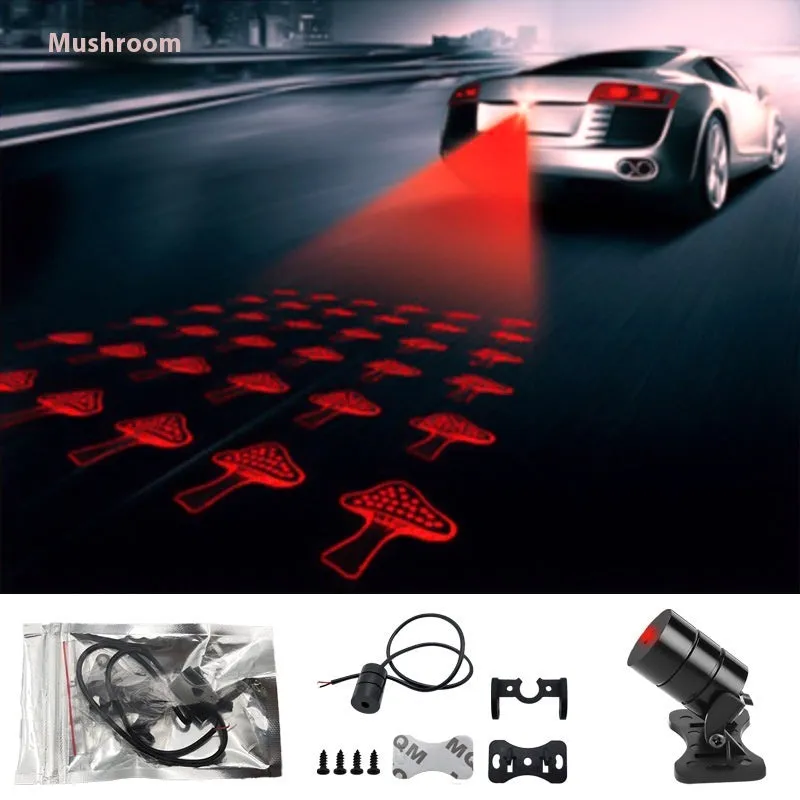 Motorcycle laser fog light unit with aluminium housing projecting star pattern on road surface.