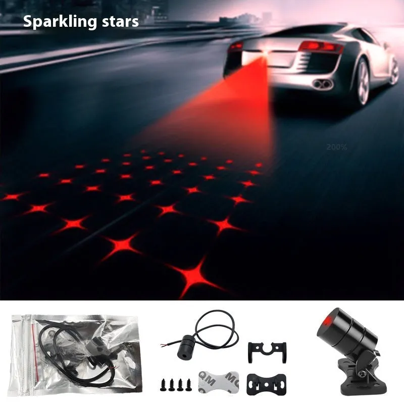 Motorcycle laser fog light unit with aluminium housing projecting star pattern on road surface.