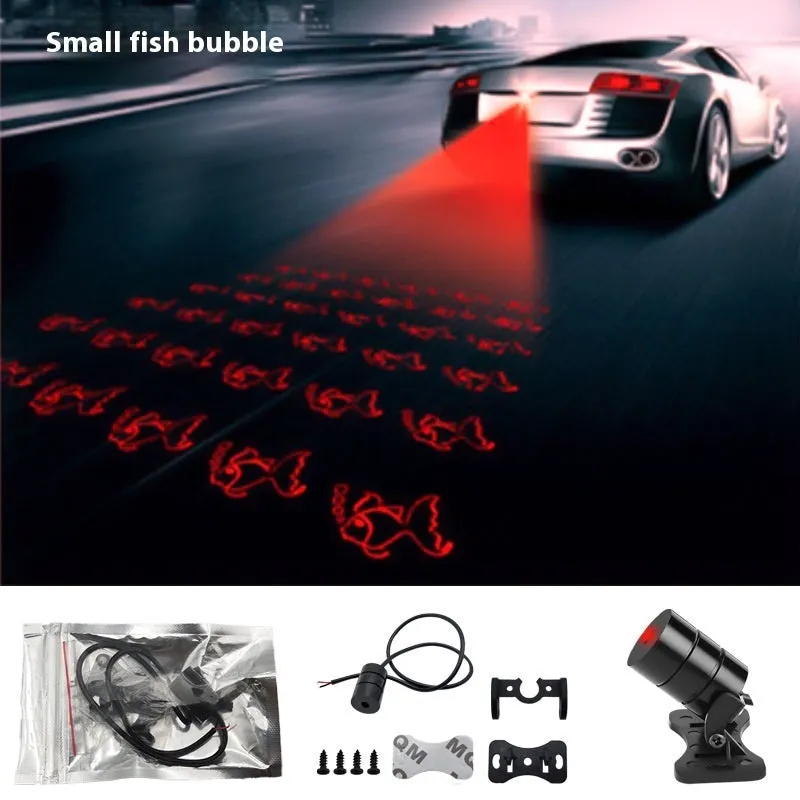 Motorcycle laser fog light unit with aluminium housing projecting star pattern on road surface.