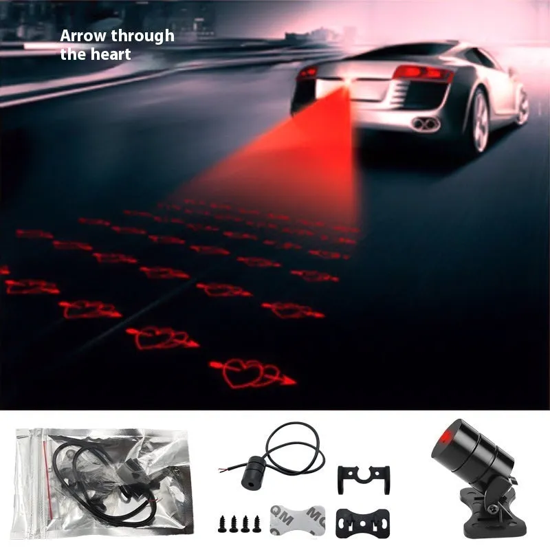 Motorcycle laser fog light unit with aluminium housing projecting star pattern on road surface.