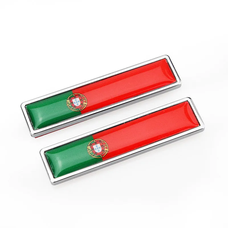 Pair of rectangular zinc alloy metal car badge stickers showing national flag designs, dimensions 58mm by 14mm.