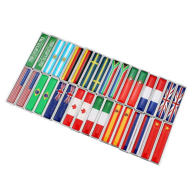 Pair of rectangular zinc alloy metal car badge stickers showing national flag designs, dimensions 58mm by 14mm.