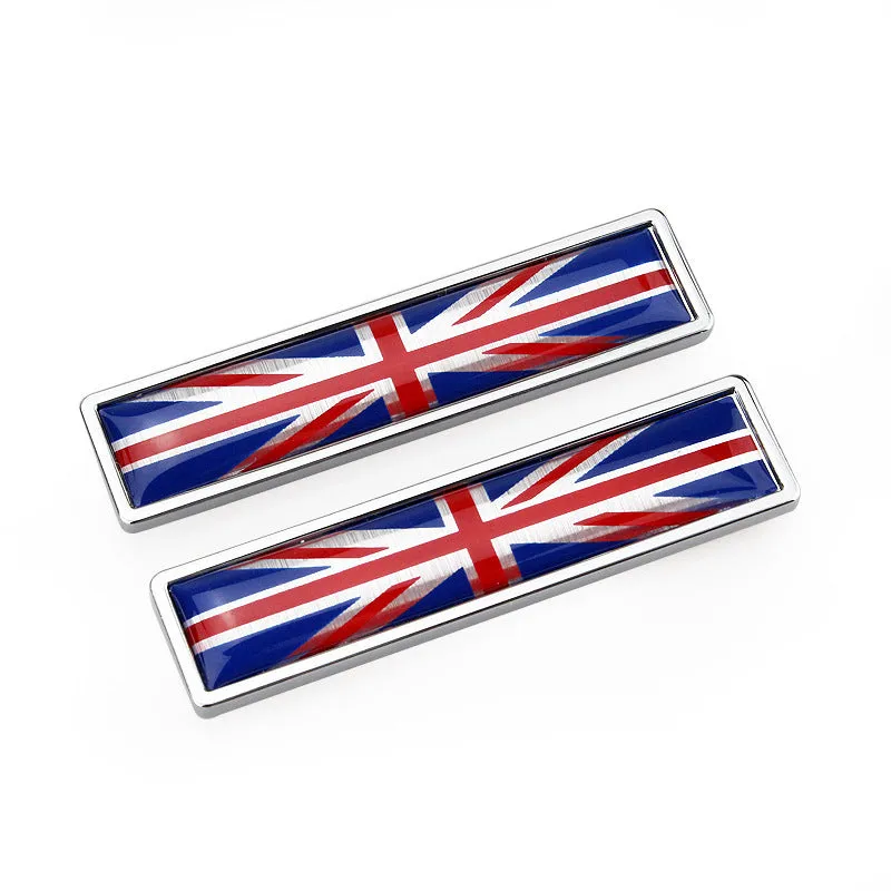 Pair of rectangular zinc alloy metal car badge stickers showing national flag designs, dimensions 58mm by 14mm.