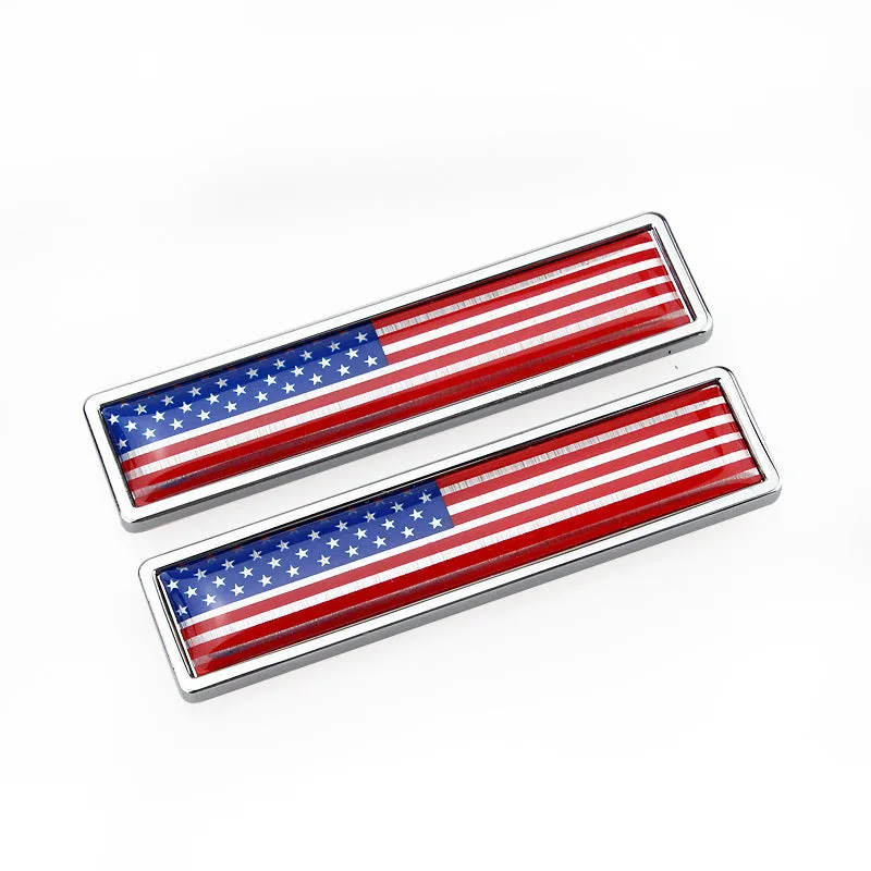Pair of rectangular zinc alloy metal car badge stickers showing national flag designs, dimensions 58mm by 14mm.