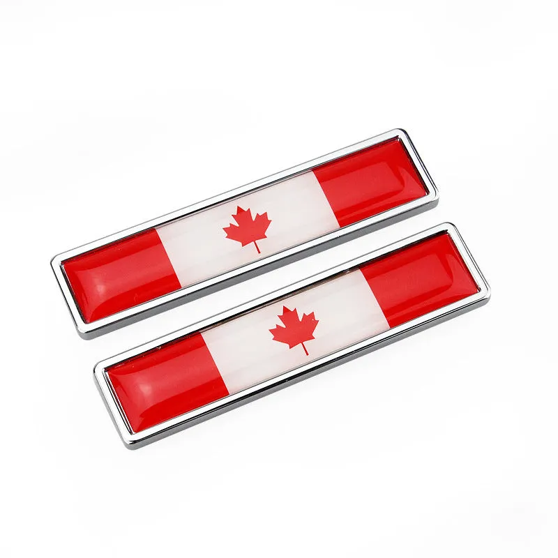 Pair of rectangular zinc alloy metal car badge stickers showing national flag designs, dimensions 58mm by 14mm.