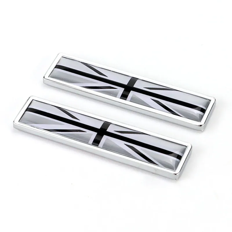 Pair of rectangular zinc alloy metal car badge stickers showing national flag designs, dimensions 58mm by 14mm.