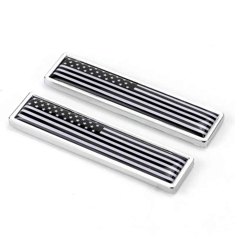 Pair of rectangular zinc alloy metal car badge stickers showing national flag designs, dimensions 58mm by 14mm.