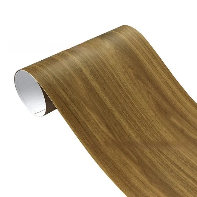 Roll of matte wood grain PVC vinyl wrap film for car colour change and customisation.