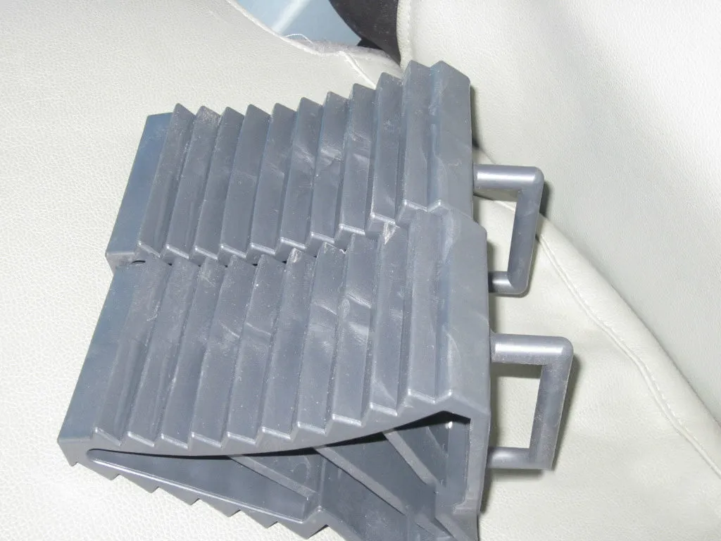 Car tyre skid stop parking locator set showing triangular anti-slip devices in black and silvery colours