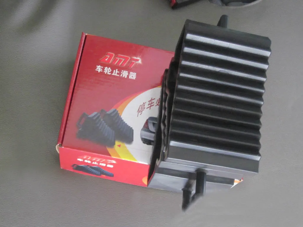 Car tyre skid stop parking locator set showing triangular anti-slip devices in black and silvery colours