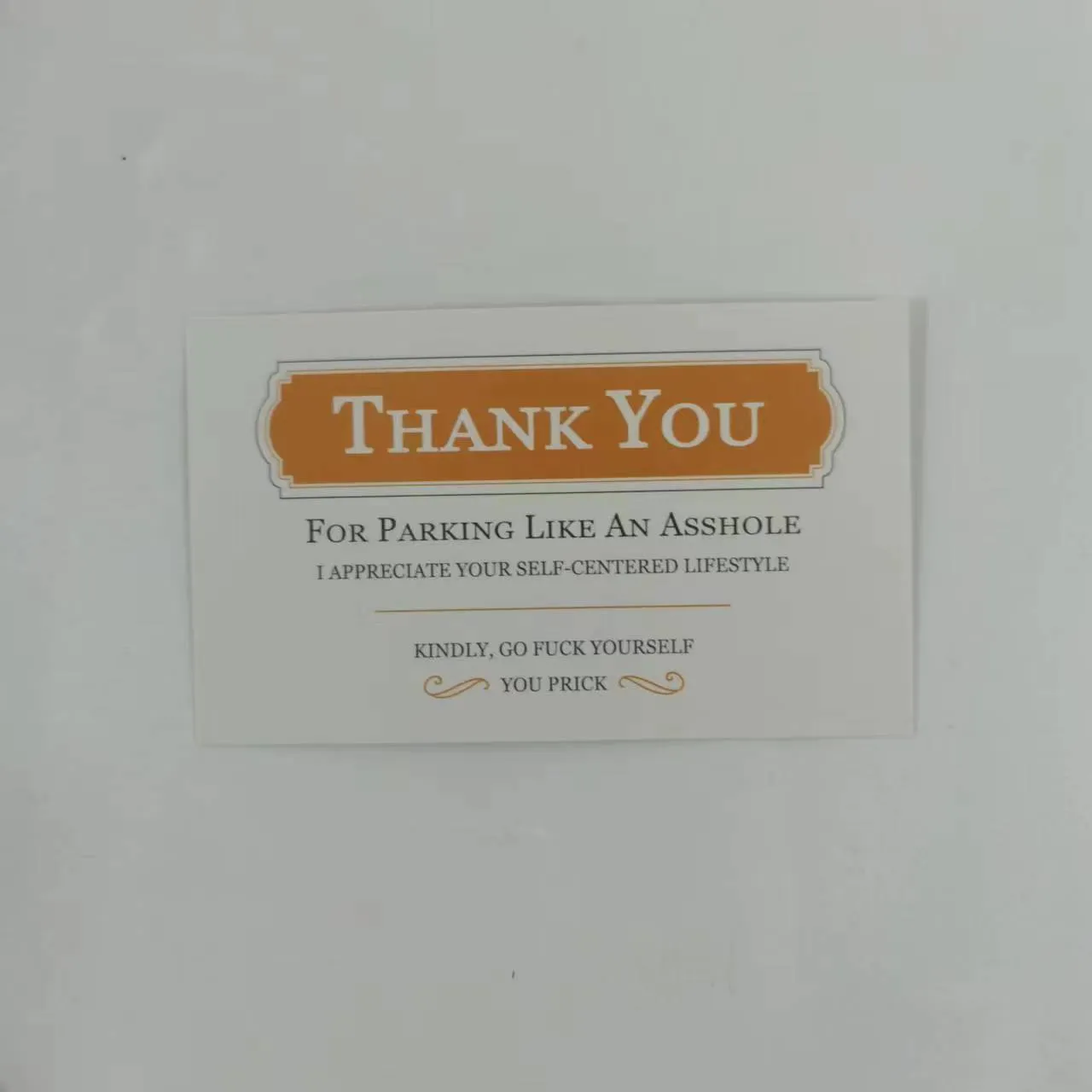 Illegal parking reminder card with middle finger design for vehicle windscreen placement