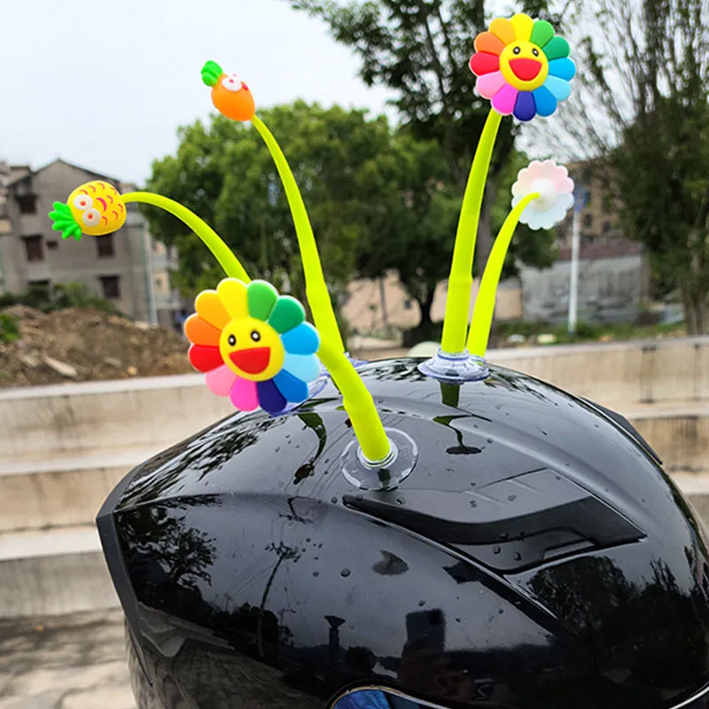 Yellow silicone sunflower decoration with a clear suction cup for helmet attachment.