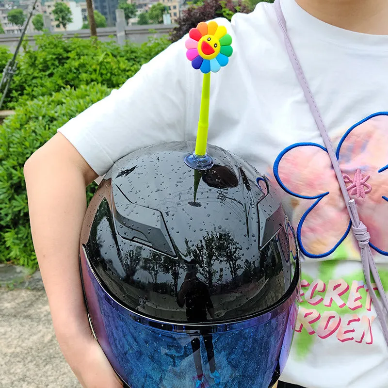 Yellow silicone sunflower decoration with a clear suction cup for helmet attachment.