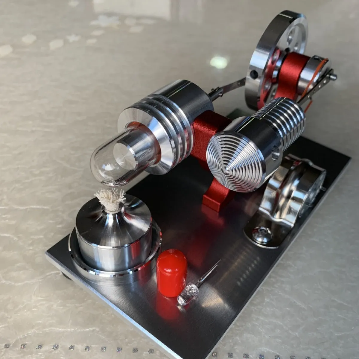 2019 Red upgrade miniature Stirling engine toy on a desk, 155x80x85mm, showing flywheel and cylinder