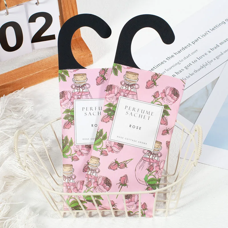Pack of five household wardrobe sachets with lavender, rose, jasmine, sandalwood, vanilla, apricot blossom aromas on a shelf