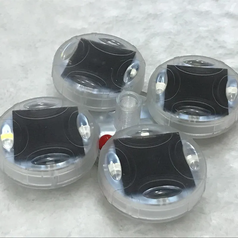 Colourful solar-powered LED hub decorative light for vehicle wheels, shown with installation screws.