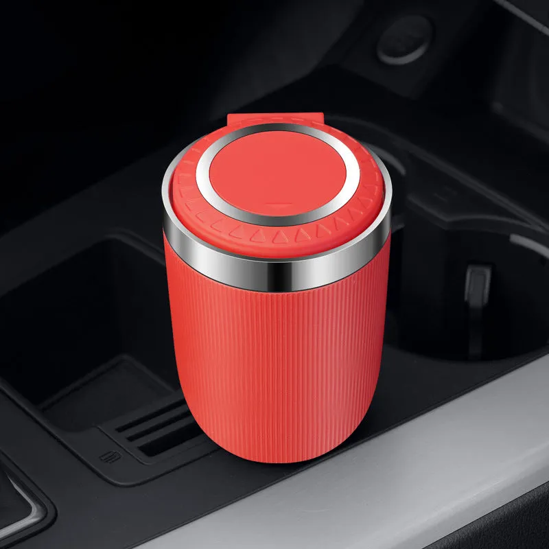 Metal ABS car ashtray with cover and blue LED light against a dark background