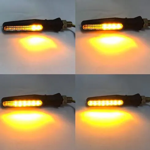 Four universal motorcycle LED turn signals with flowing water amber light, black flexible rubber housing, 2.5 x 11cm each