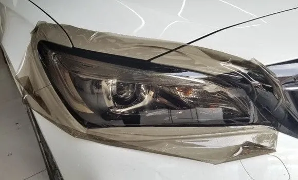 Roll of 30cm wide dark grey TPU protective film for car LED lamp protection.
