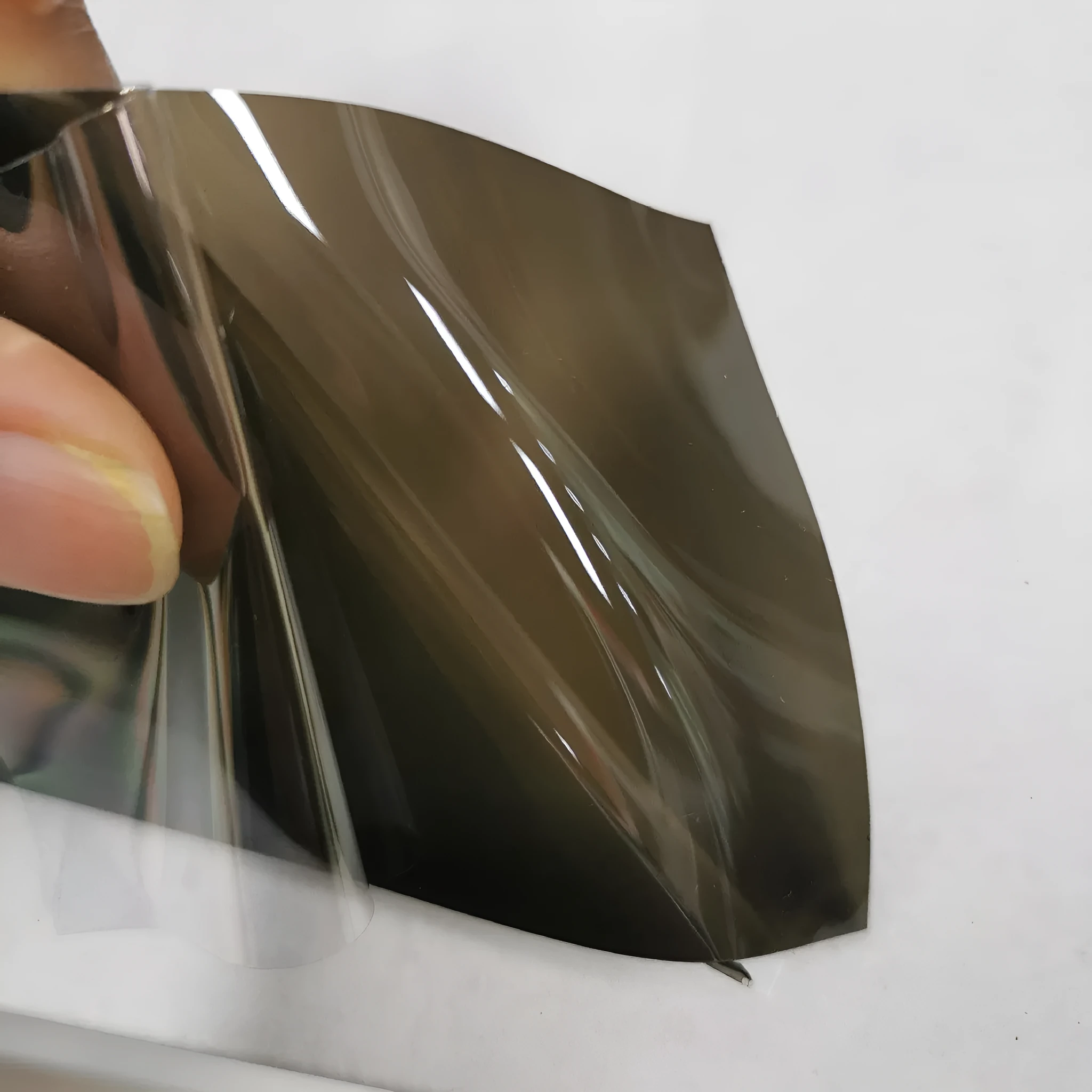 Roll of 30cm wide dark grey TPU protective film for car LED lamp protection.