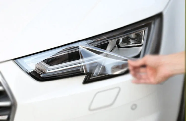 Roll of 30cm wide dark grey TPU protective film for car LED lamp protection.